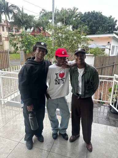 Four Earthians outside a fence