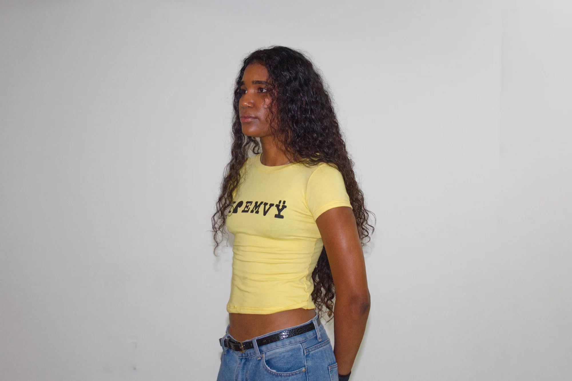 Yellow I love EMVŸ baby tee from a three-quarter angle