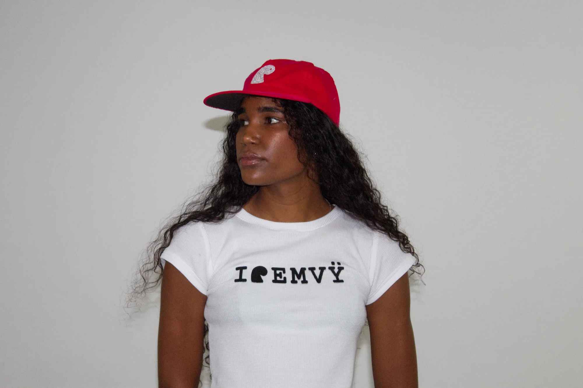Red corduroy EMVŸ cap from a three-quarter angle