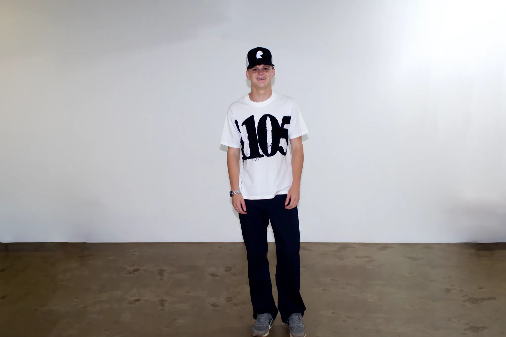 NMBRS T-shirt full length, worn with the black trucker cap