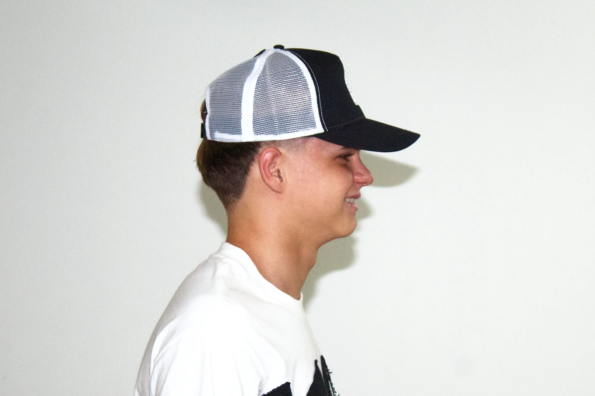 Black trucker cap in profile from the other side