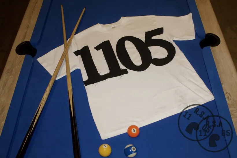 NMBRS T-shirt with 1105 print, on blue pool table felt